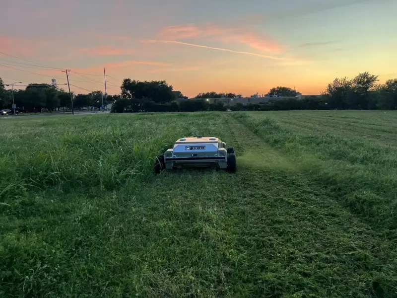 Amotrol A60i cutting a clean line through heavy overgrown grass at dusk